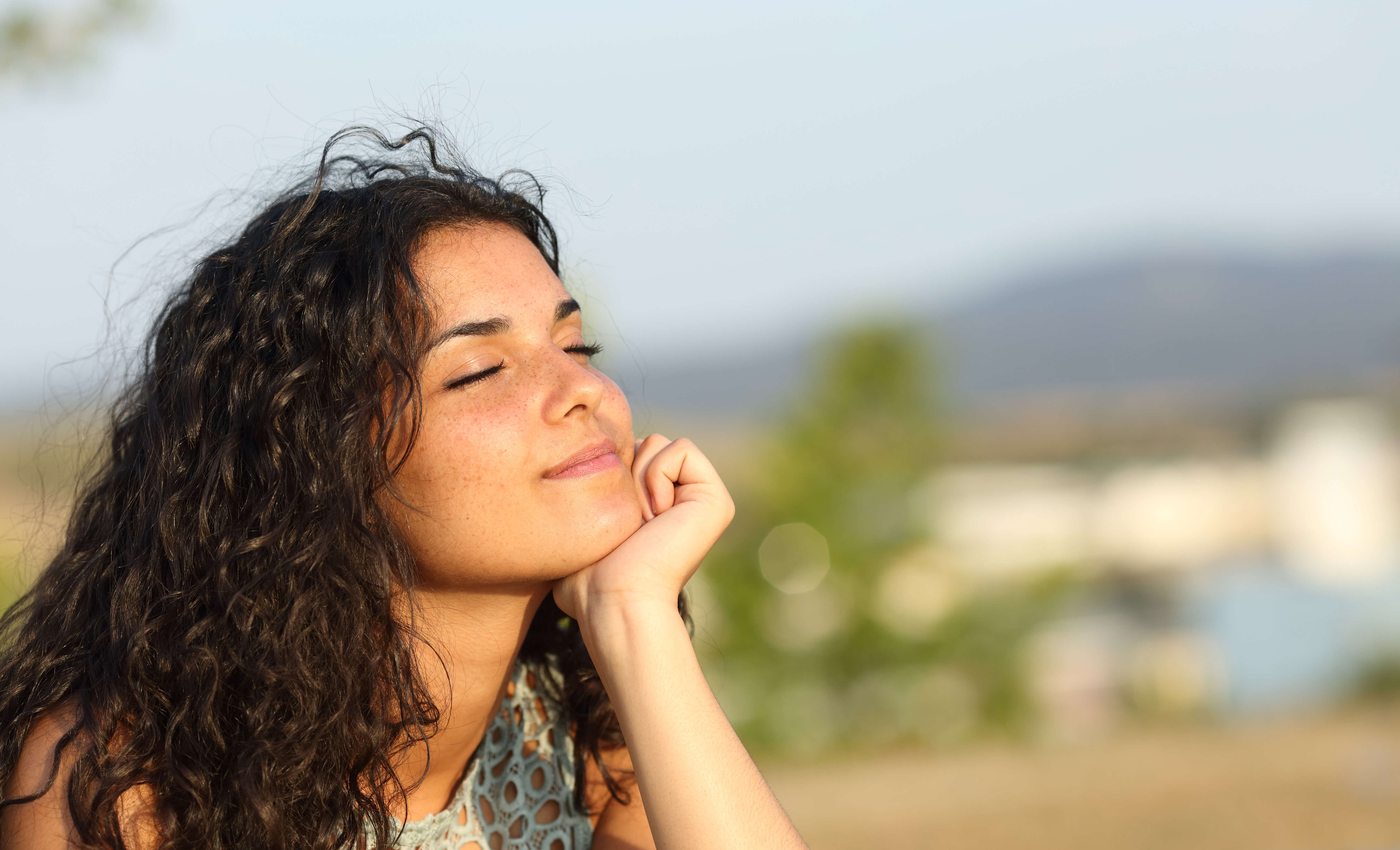 Woman smiling and looking at peace