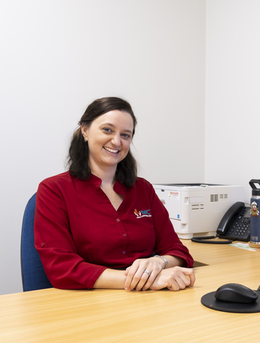 Speech Pathologist sitting at her desk
