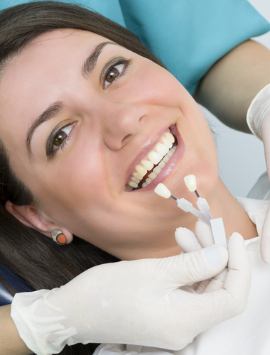 Dentist showing patient a crown.