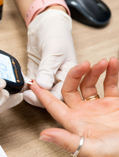 Pin being pricked to test blood sugar levels