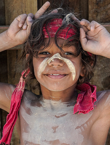 First Nations child posing in cultural dress