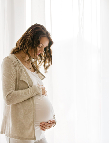 Pregnant woman holding her belly