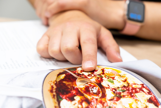 Dietitian pointing to a recipe in a book
