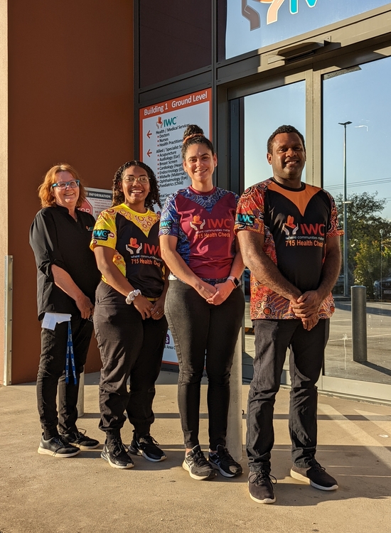 Indigenous Health Workers in front of sign