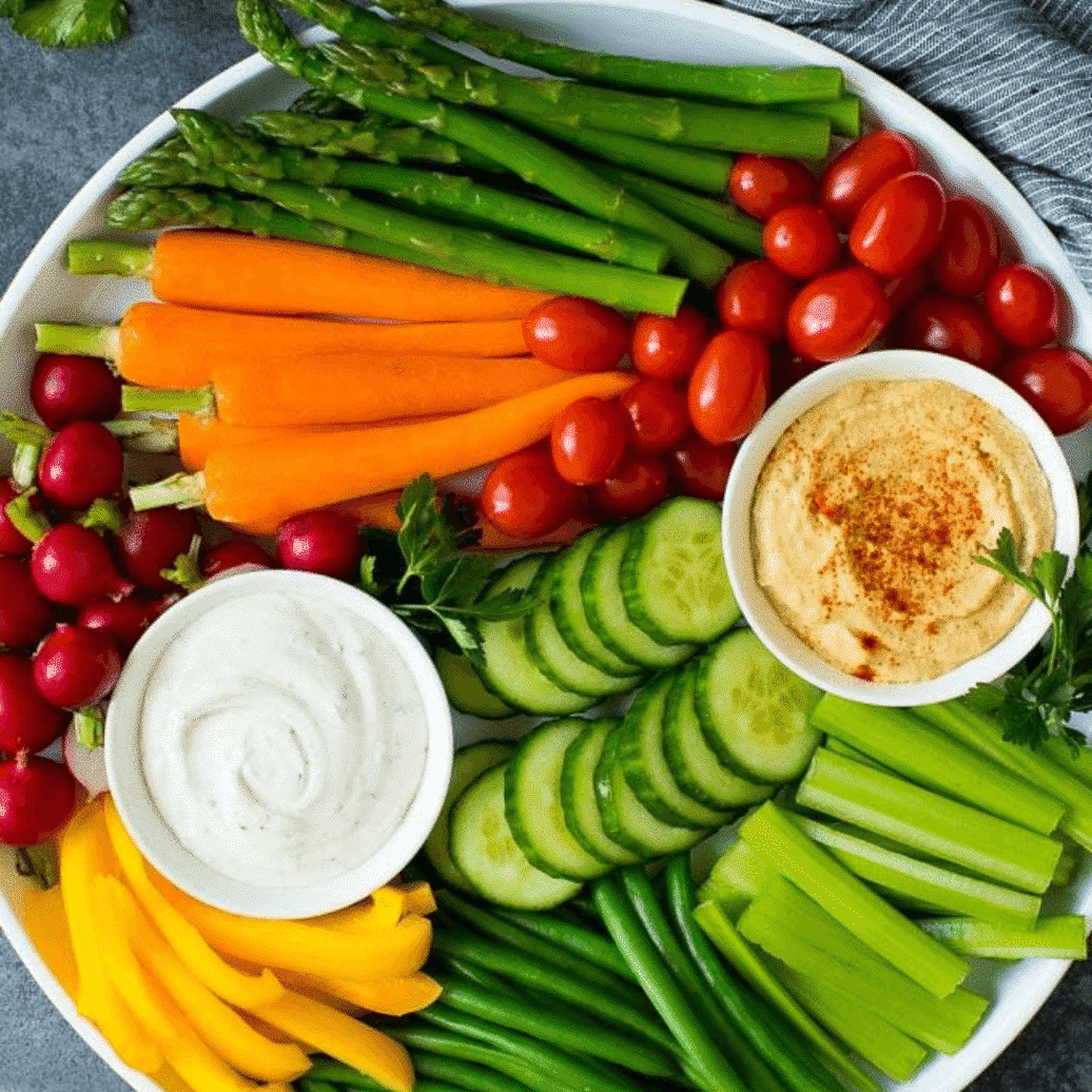 Plate of variety of colourful Vegetables with hummus dips