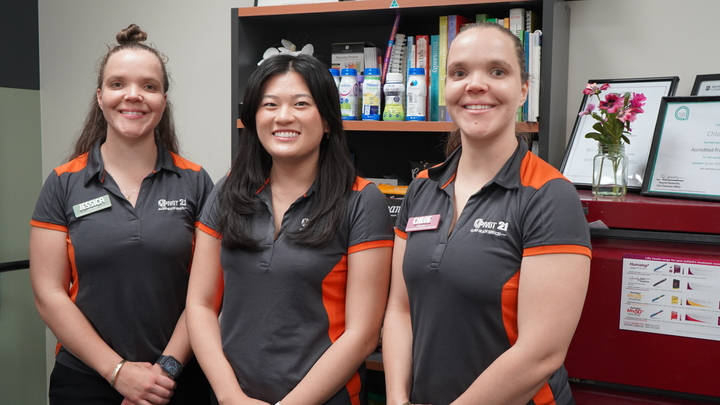 team of dietitians stand in front of food samples