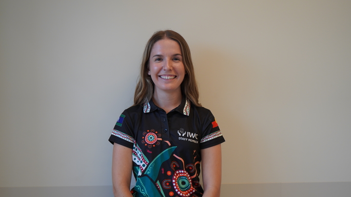 Zoe standing in front of a wall