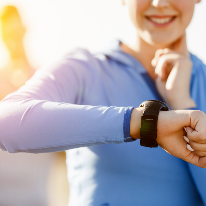 woman checks pulse after a run