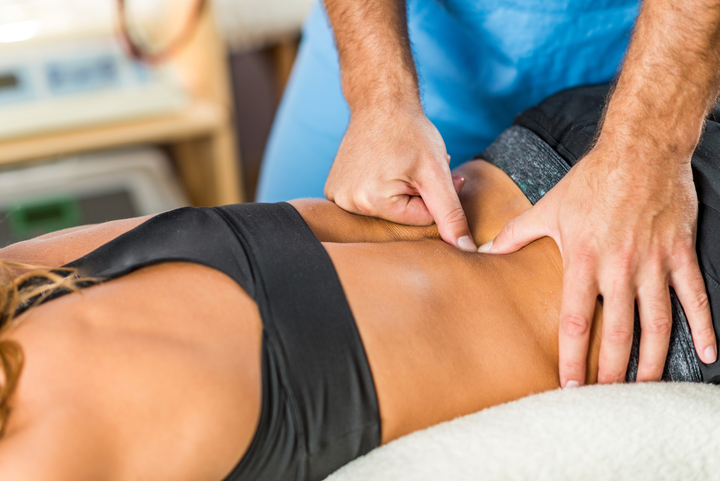 Physiotherapist treats lower back pain