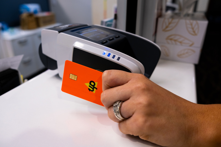 Woman using a card to pay for services