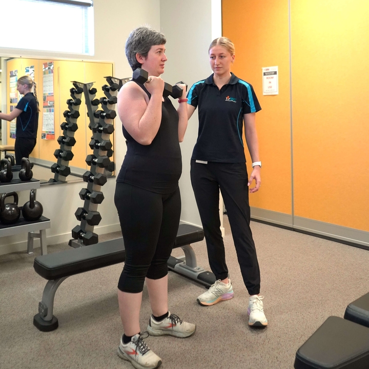 Exercise physiologist works with a patient