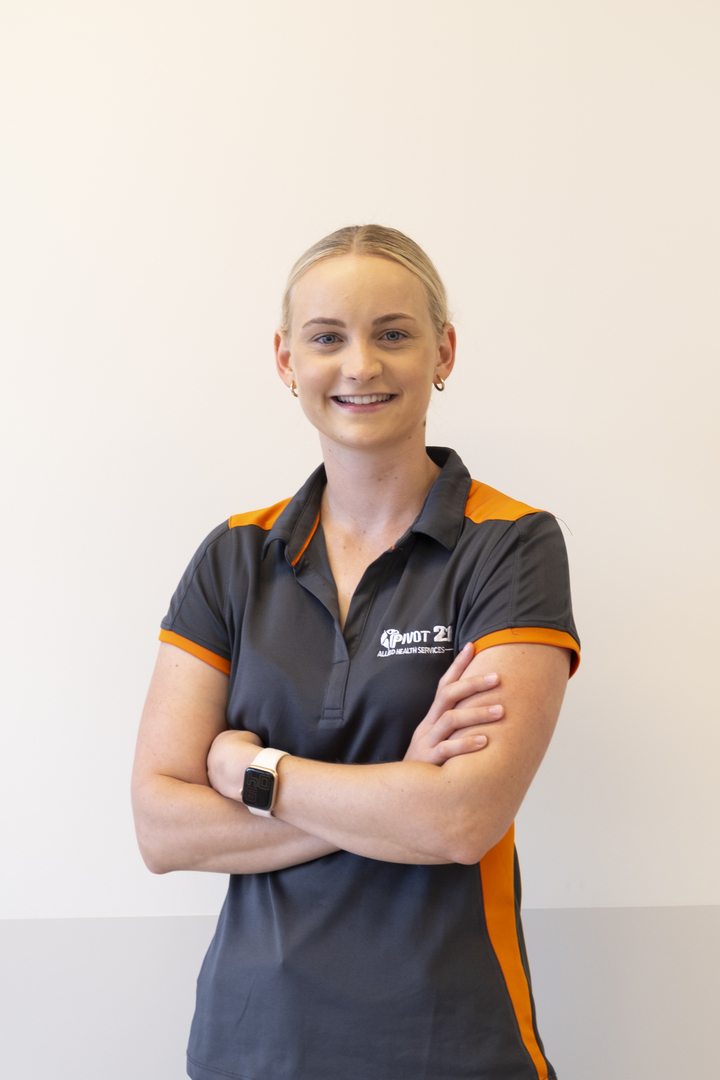 Danielle standing with her arms crossed