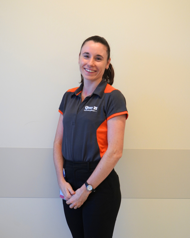 Kate standing in front of a wall