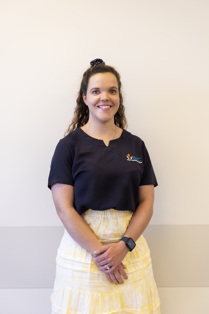 Jess standing in front of a wall