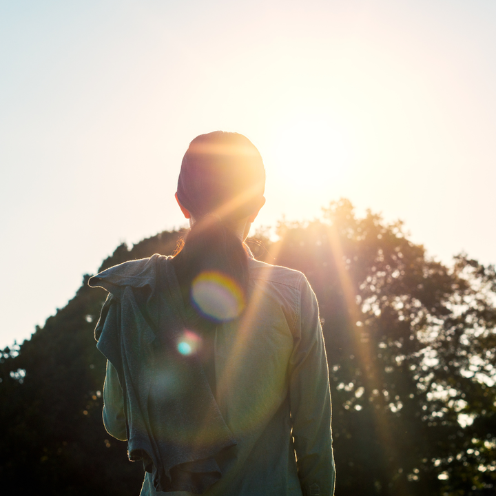 woman faces morning sunshine