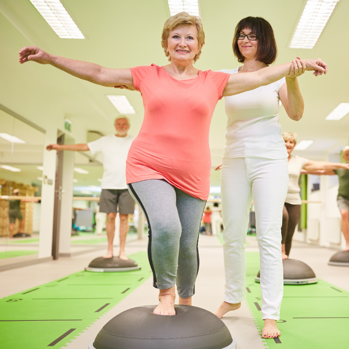 physio helps older woman balance