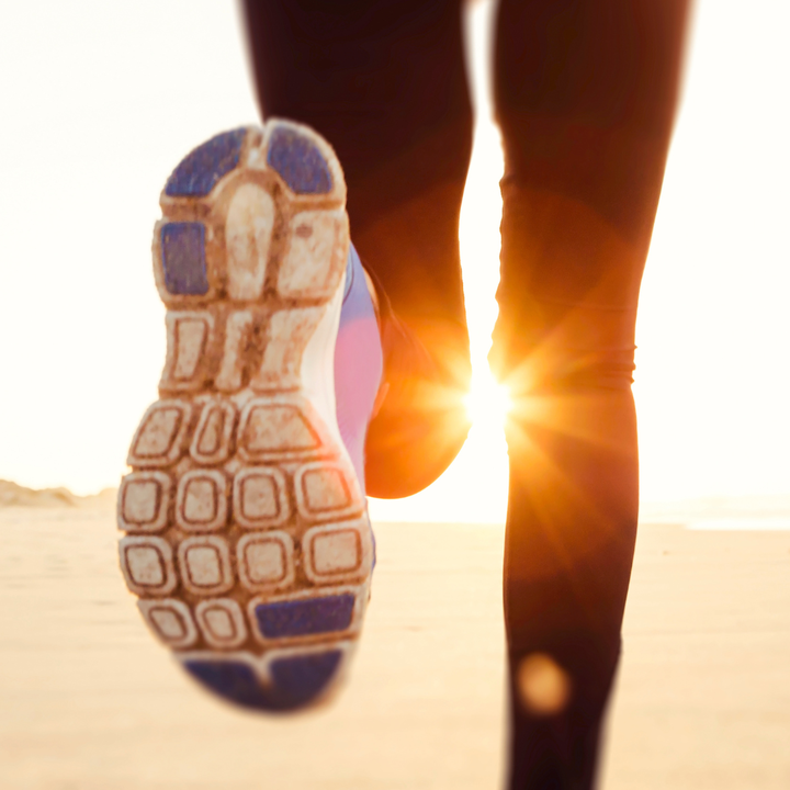 woman mid step while running.
