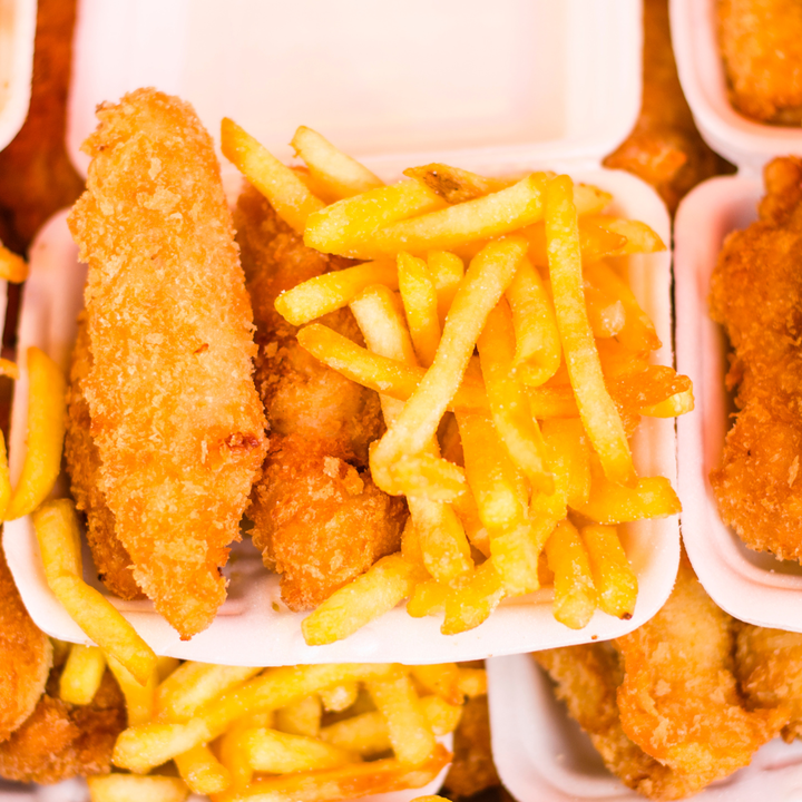 take out container containing deep fried fish and chips