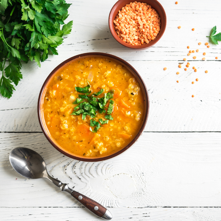 Bowl of soup, spoon and lentils