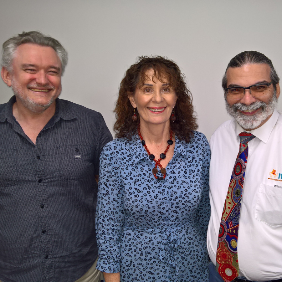 Group of 3 individuals stand and face the camera