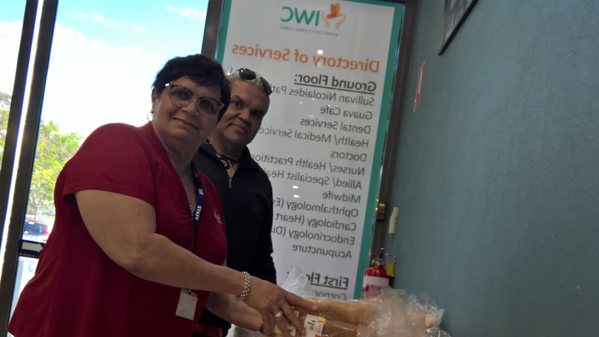 IWC Staff stand with donated Bread.