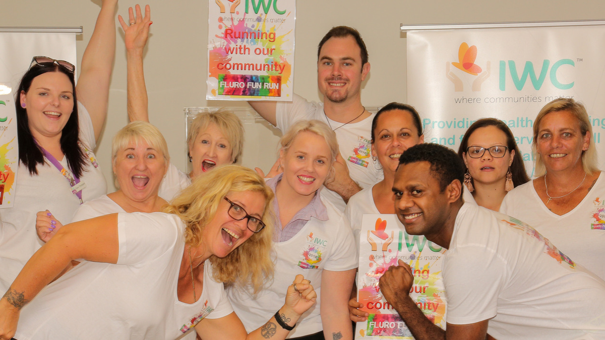 Group of IWC Staff Celebrate the Upcoming Fluro Run