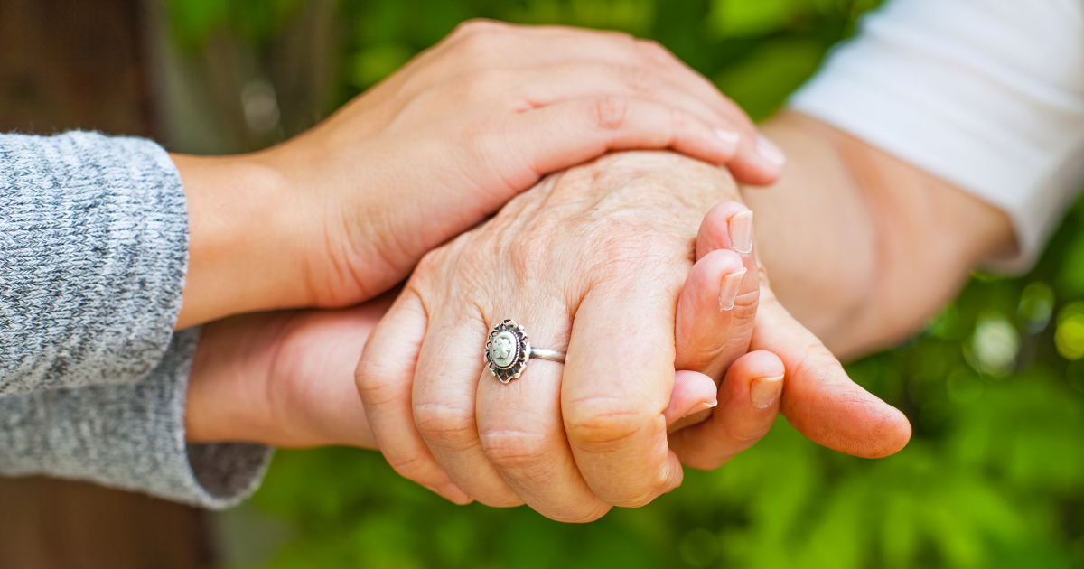 Younger hands holding older hands