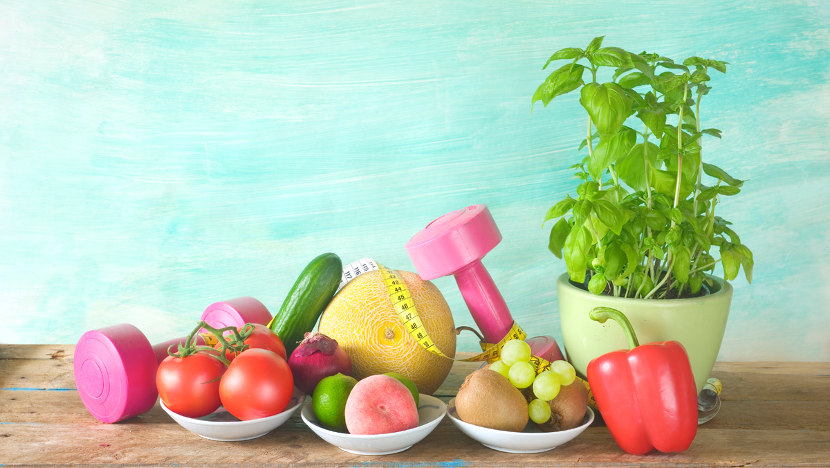 selection of food and pink dumbbells' sit on a table