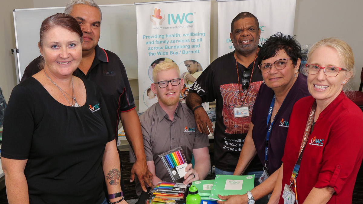 Social Health and Wellbeing team stand with donated school supplies