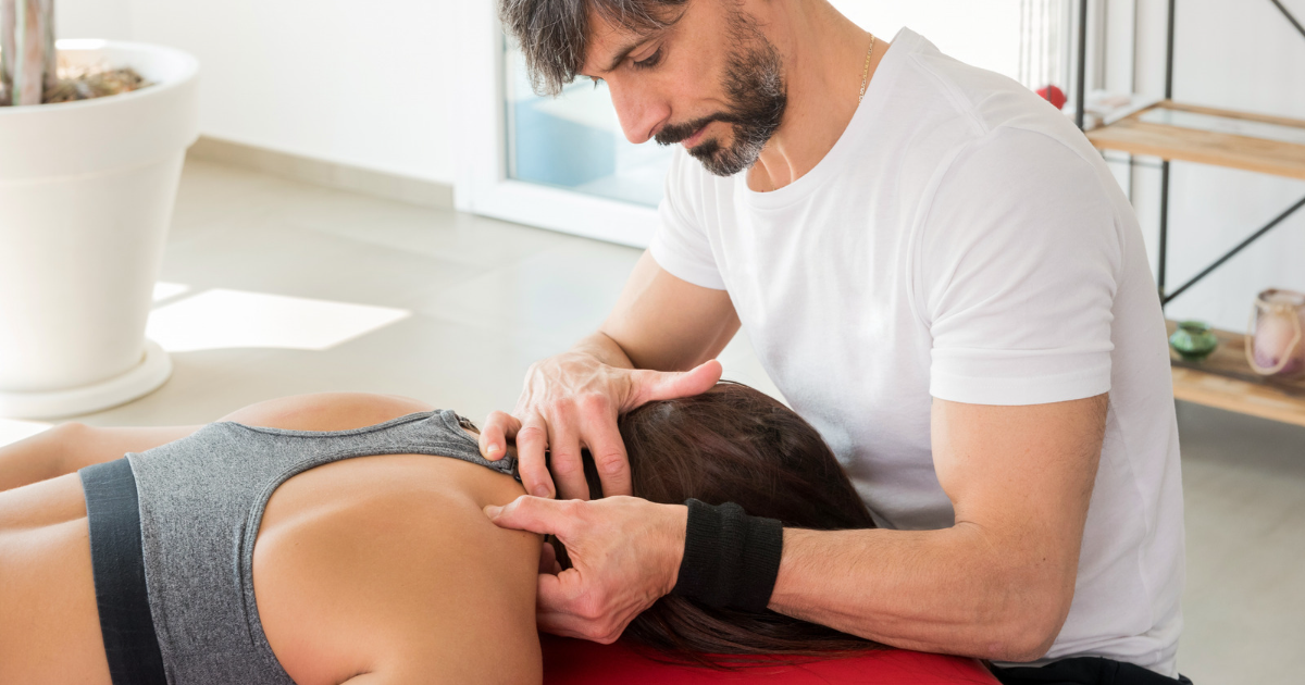 physiotherapist performs trigger point release on a shoulder