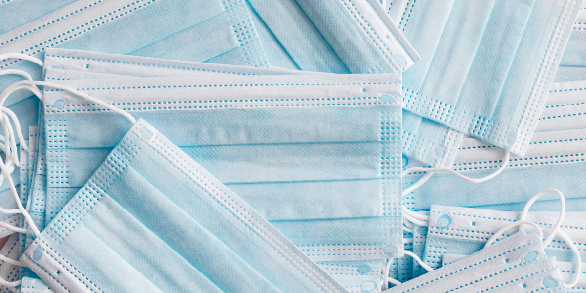 disposable face masks in a messy pile